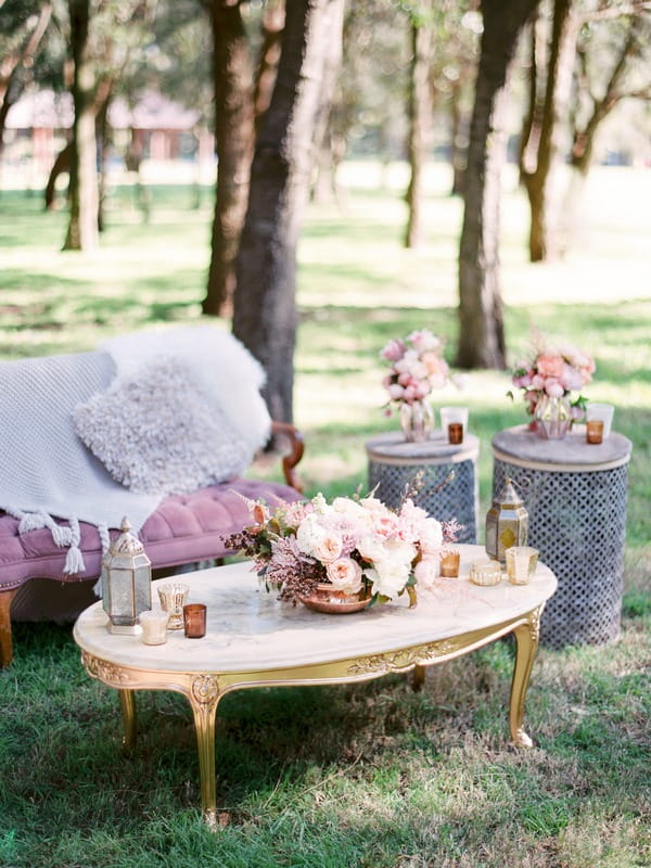 Table with wedding flowers in woodland