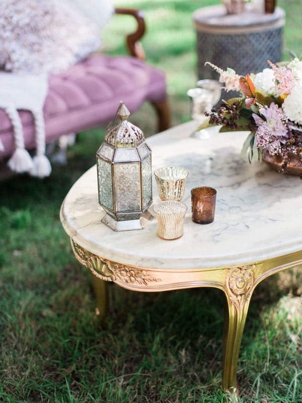 Lantern and votives on table