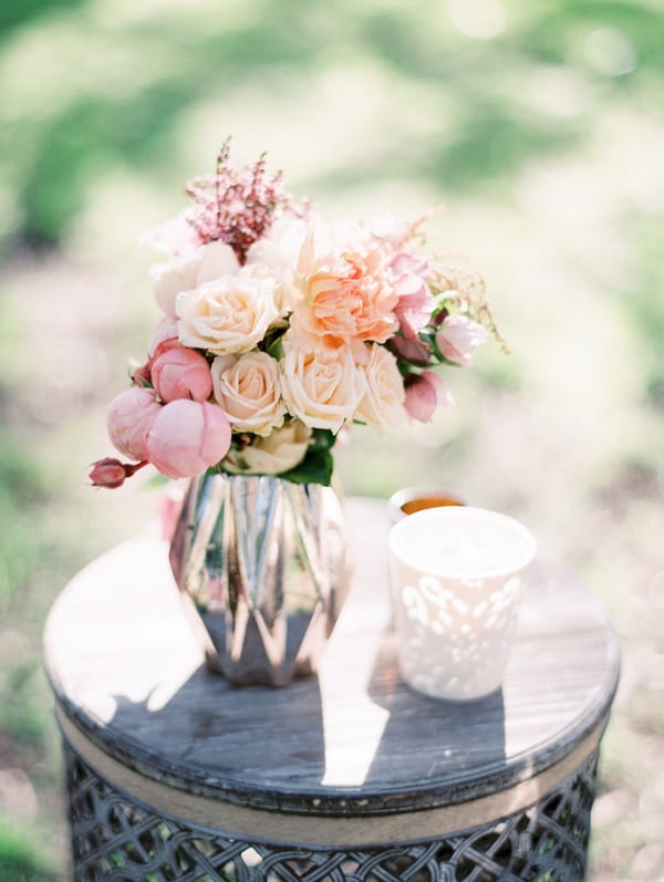 Vase of pastel coloured wedding flowers