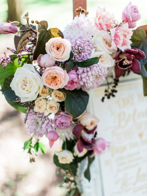 Flowers on corner of frame on wedding sign