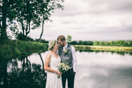 Bride and groom looking into each others eyes nest to lake - Picture by Jess Yarwood Photography