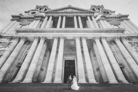 Bride and groom standing on steps of St Paul's Cathedral - Picture by Nick Ray Photography