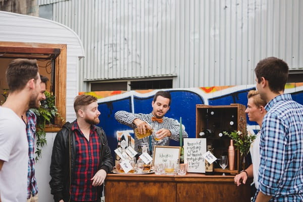 Man pouring whisky at outdoor whisky bar