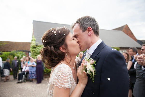 Bride and groom kissing at Packington Moor