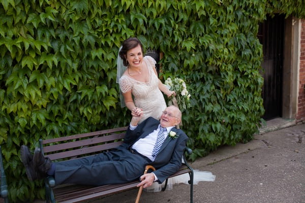 Bride with man laying on bench