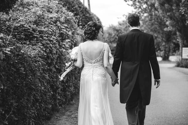 Bride and groom walking holding hands at Packington moor