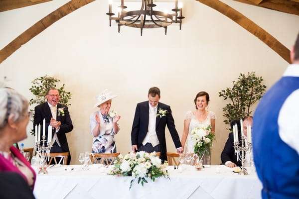 Bride and groom take seats at top table