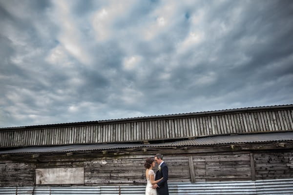 Bride and groom outside barn at Packington Moor