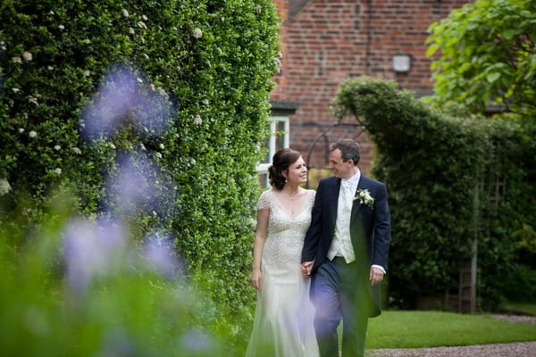 Bride and groom walking in grounds of Packington Moor