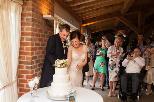 Bride and groom cutting cake at Packington Moor wedding