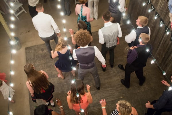 Lines of wedding guests dancing