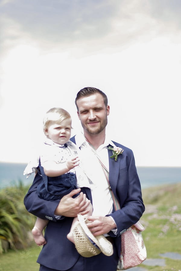 Groom holding pageboy son