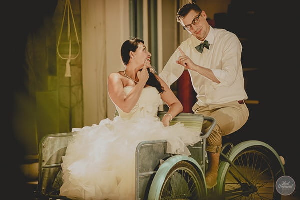 Bride and groom sitting in cart for post wedding shoot picture