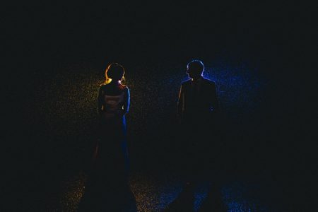 Bride and groom standing in rain in the dark - Picture by Andy Hudson Photography