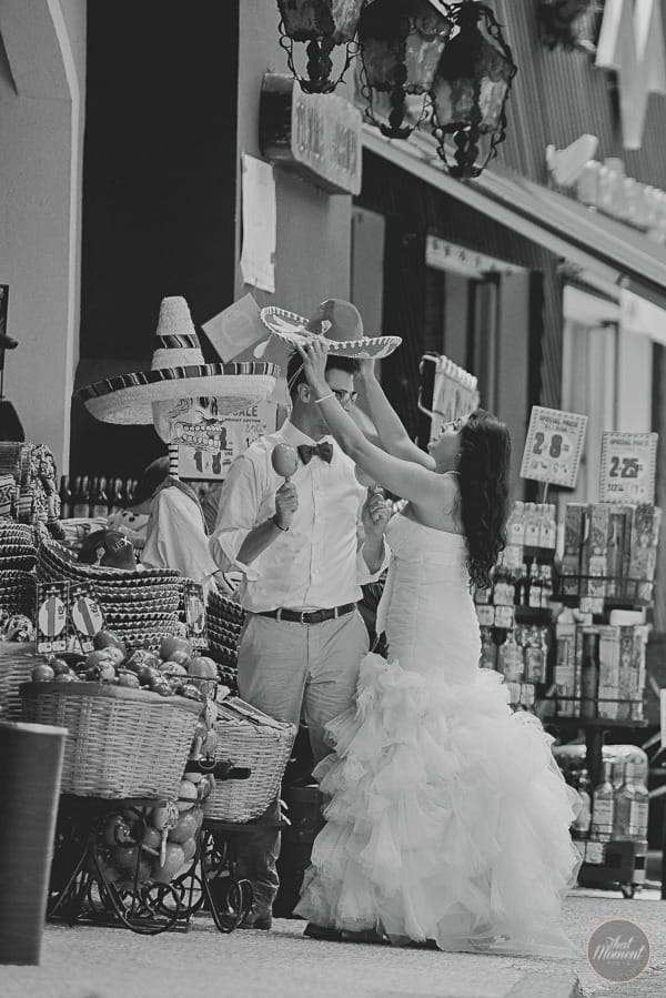 Bride putting sombrero on groom's head