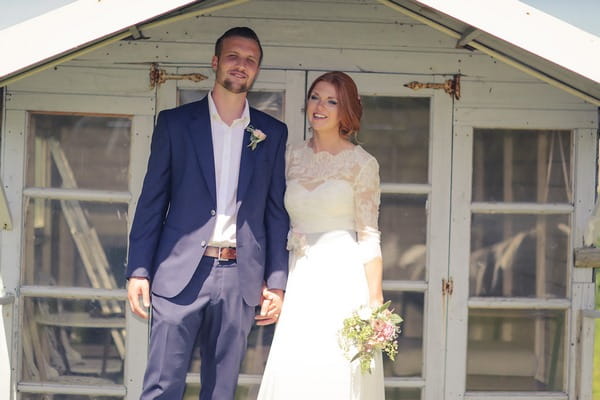 Bride and groom outside summer house