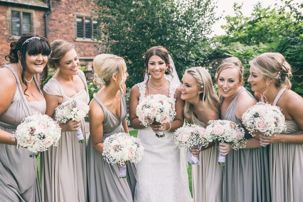 Bride with bridesmaids in silver and grey dresses