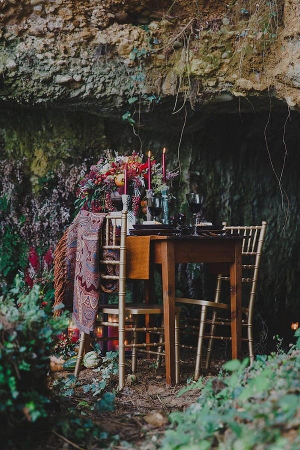 Rustic dinner table at entrance to cave