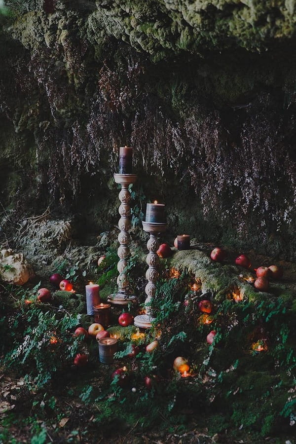 Candles and apples in woods