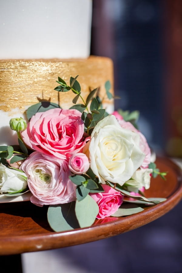 Flowers at bottom of wedding cake