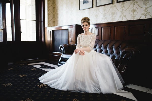 Bride sitting on sofa in The Duke of Cornwall Hotel