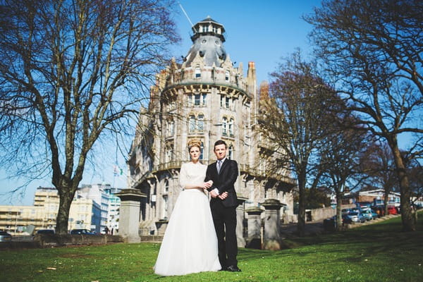 Bride and groom in front of The Duke of Cornwall Hotel