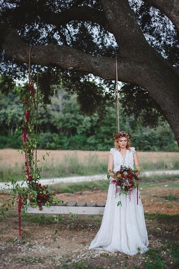 Boho bride by tree swing