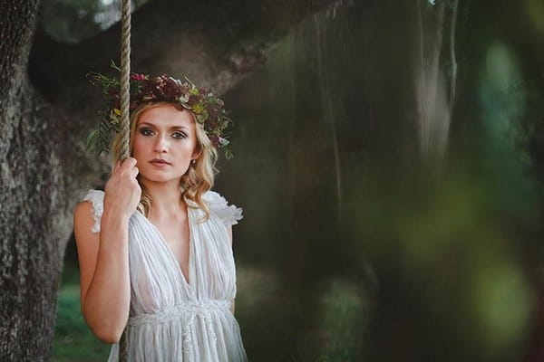 Bride holding rope of swing