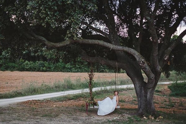 Bride laying on swing