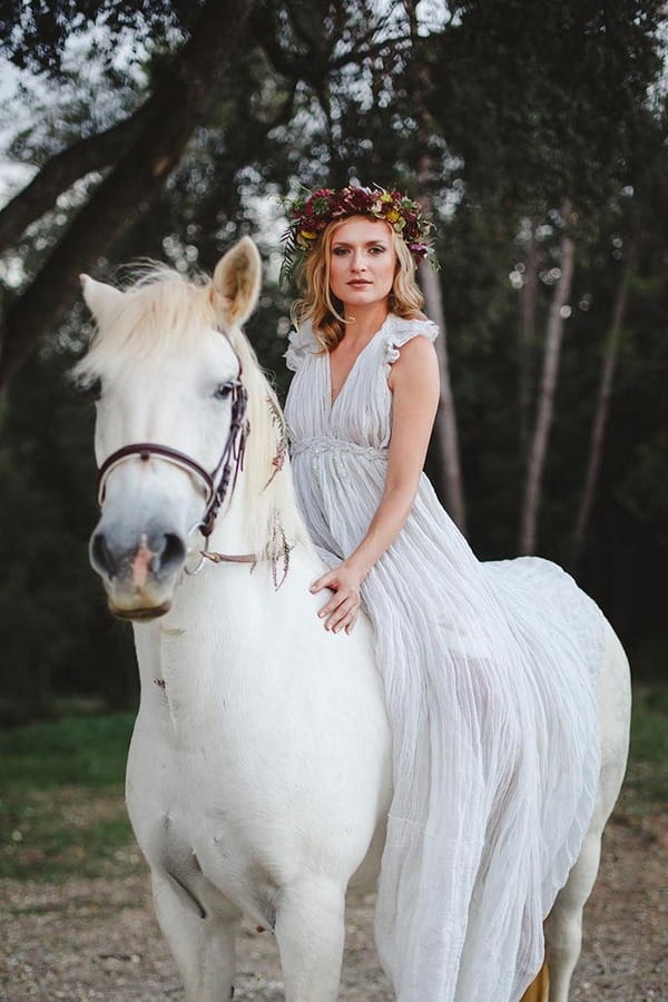 Boho bride sitting on horse