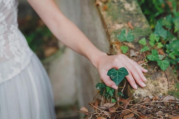 Bride's hand touching leaf