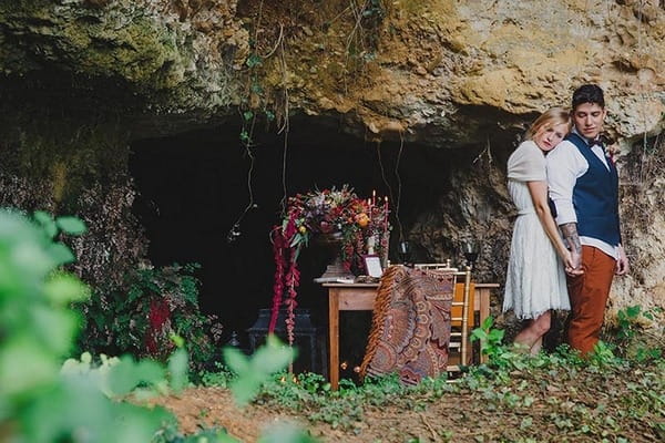 Couple by entrance to cave