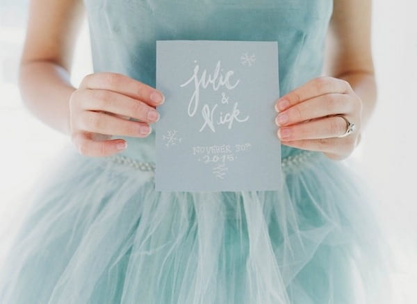 Bride holding wedding invitation