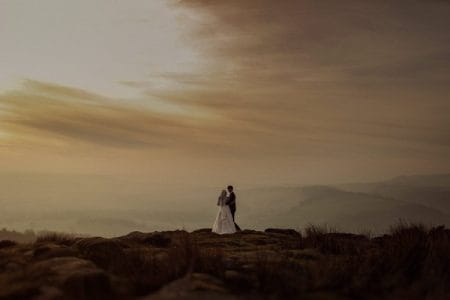 Bride and groom on top of hill in Peak District - Picture by Jess Petrie Photography