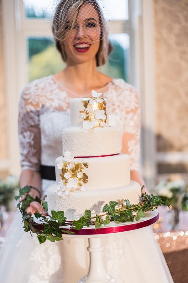 Bride holding winter wedding cake