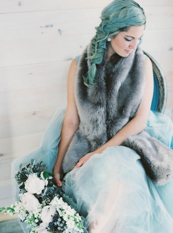 Bride sitting holding bouquet