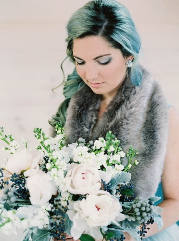 Bride looking at bouquet