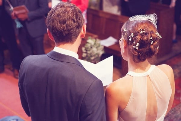 Bride and groomr eading in church