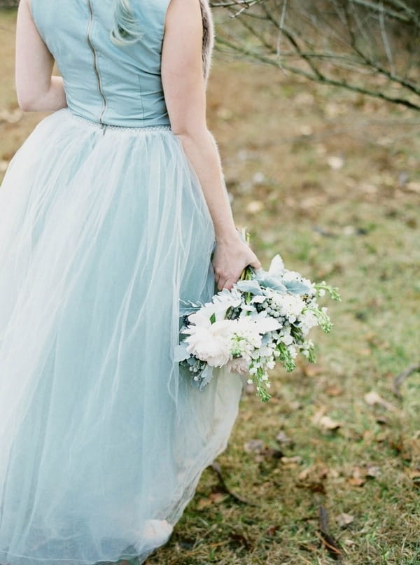 Bride walking holding winter wedding bouquet