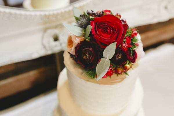 Floral cake topper on winter wedding cake