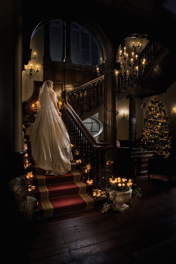 Bride walking up staircase at Wyck Hill House