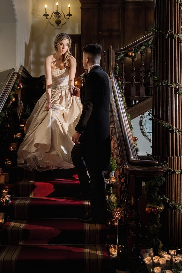 Bride and groom standing on stairs at Wyck Hill House