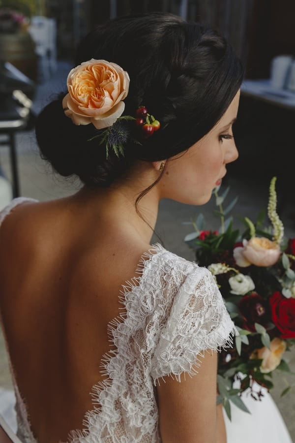 Peach flower in bride's hair