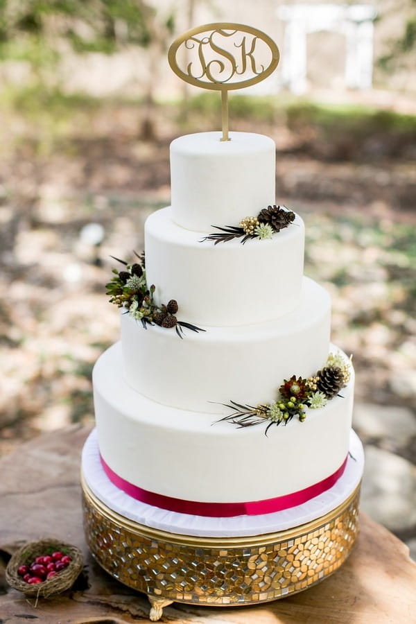 Winter wedding cake with red ribbon