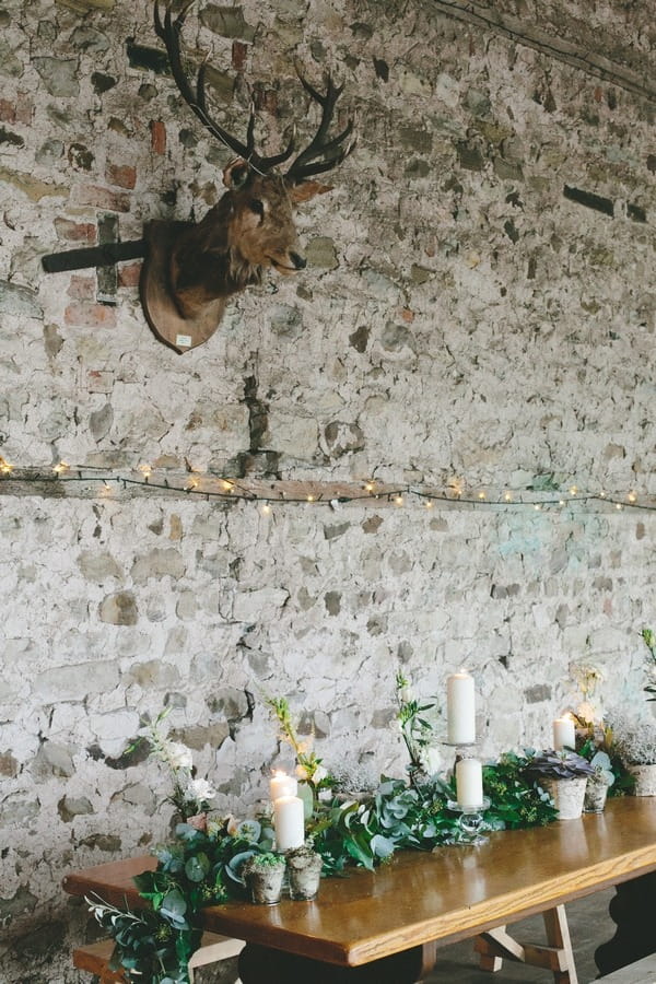 Stag head on wall above wedding table