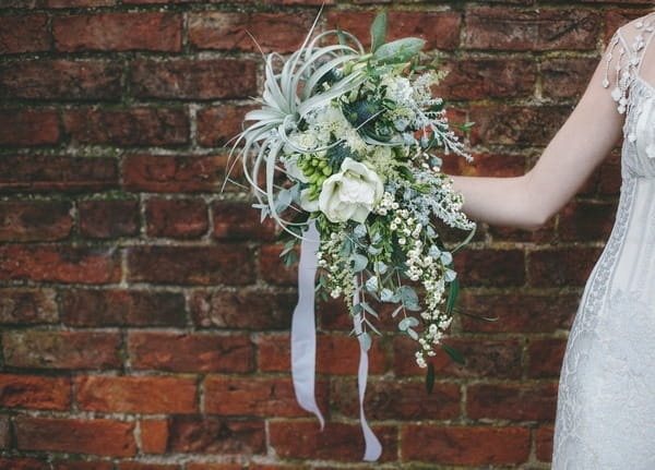 Bride holding out winter bouquet