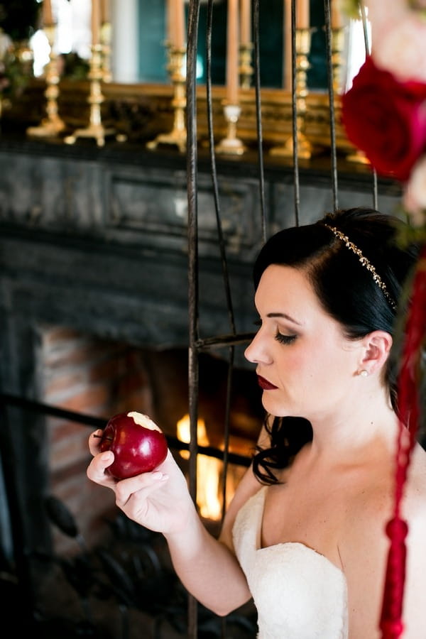 Snow White bride taking bite of apple