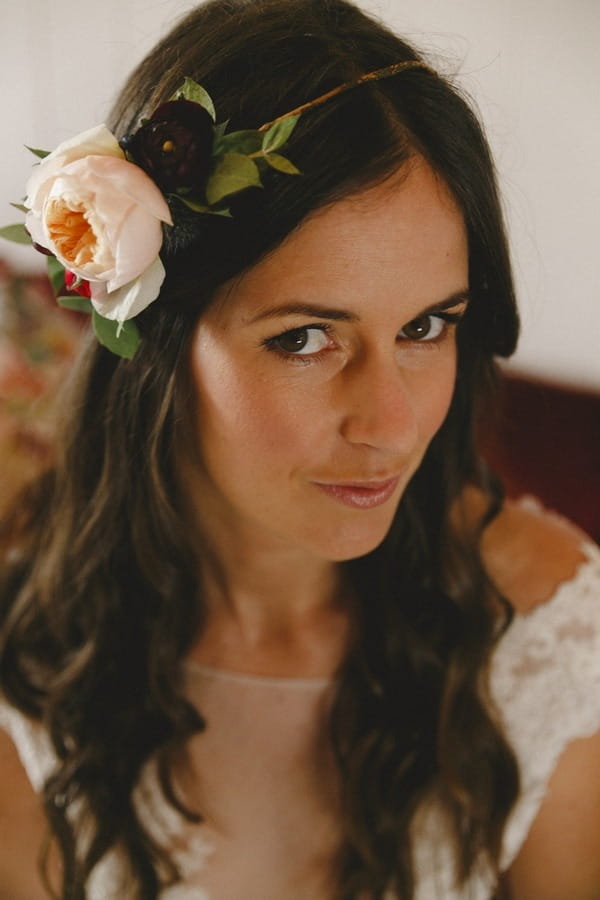 Bride with floral headband gazing at camera