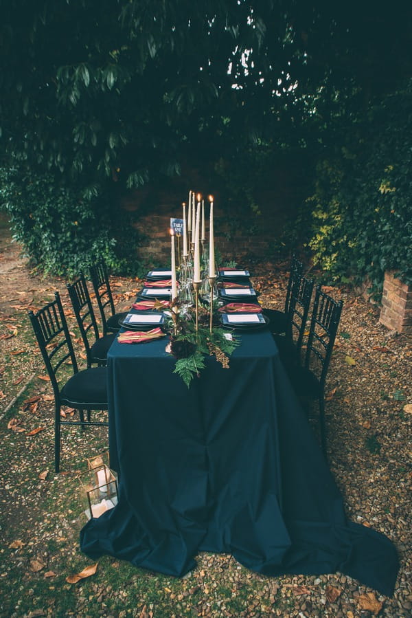 Wedding table with dark blue trailing tablecloth