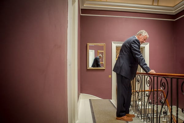 Father waiting for bride at top of stairs